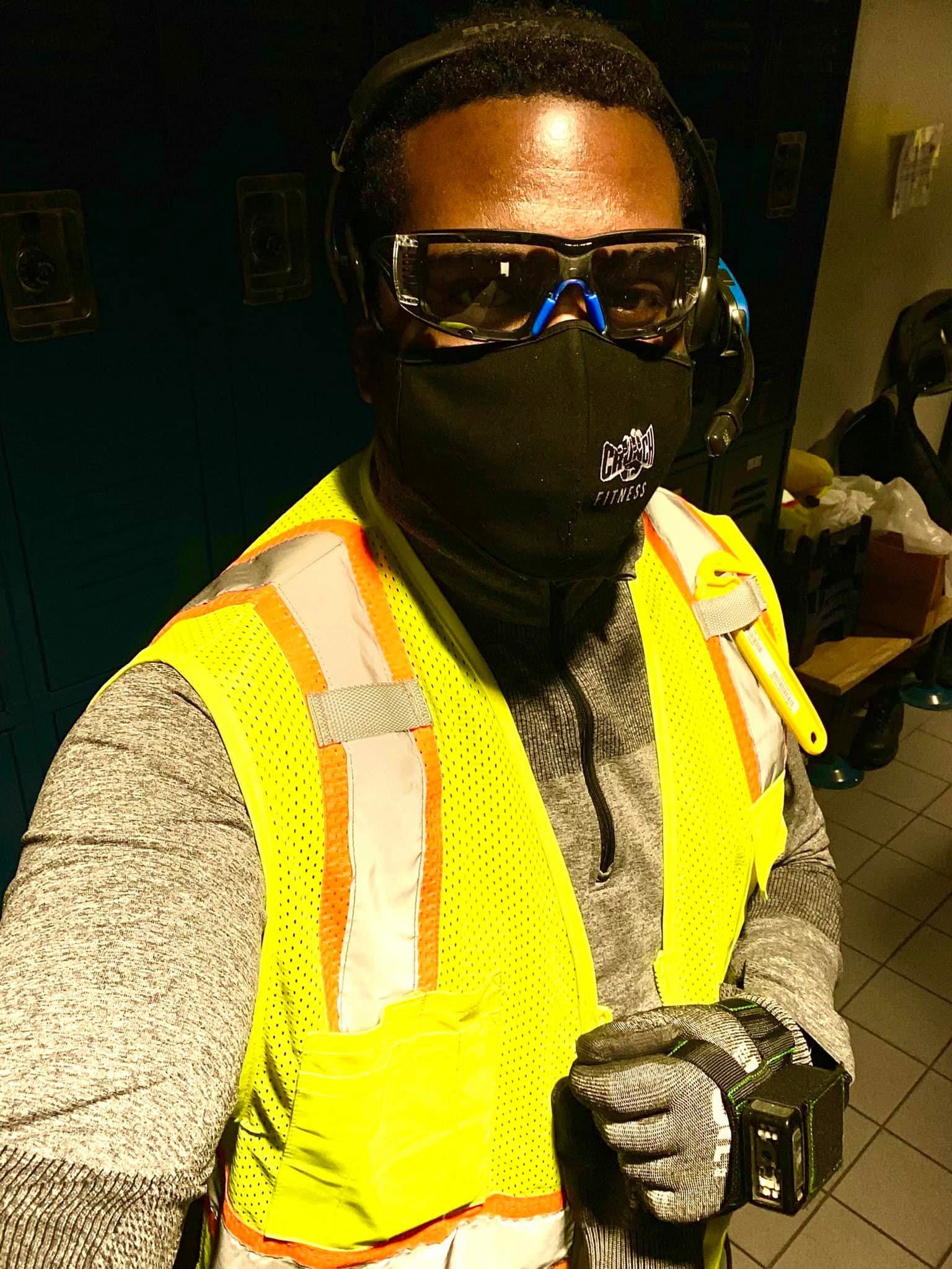 Miles working as a commercial surveyor for a large tech company before transitioning into real estate wholesaling and California cash home buying, wearing safety vest, goggles, and ear protection on a job site