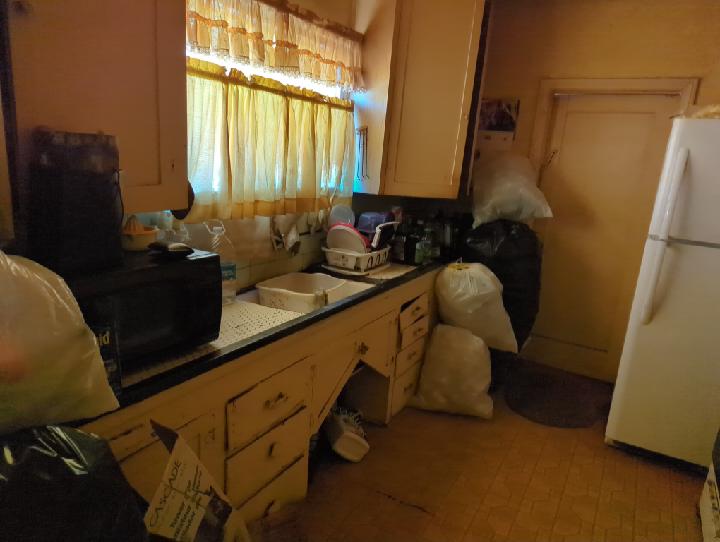 Hoarder property kitchen before renovation in Tyrone's inherited California house